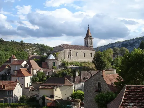 View of Cabrerts village bourg with hills ridges and structured sky on the horizon